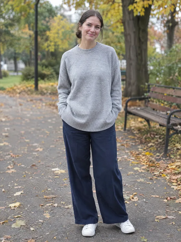 A shopper's own photo, in a grey jumper and jeans in a park